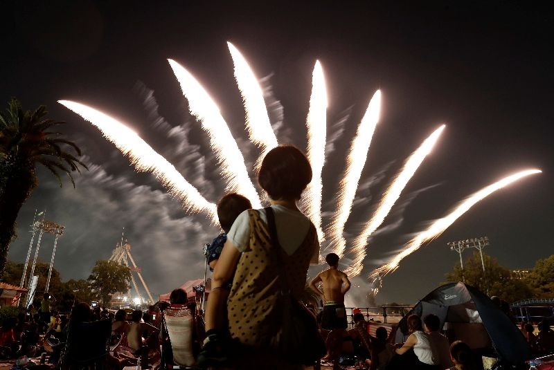 Visitors watch fireworks, amid the coronavirus disease (COVID-19) outbreak, at Toshimaen amusement park which will close 94 years after it first opened with part of the site be turned into a new Harry Potter theme park in 2023, in Tokyo, Japan . REUTERS/Issei Kato